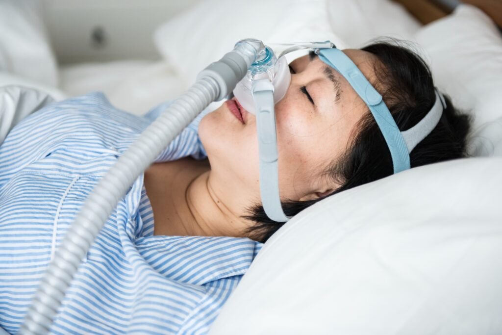 Woman sleeping with CPAP mask showing overnight oxygen and airflow monitoring for sleep apnea